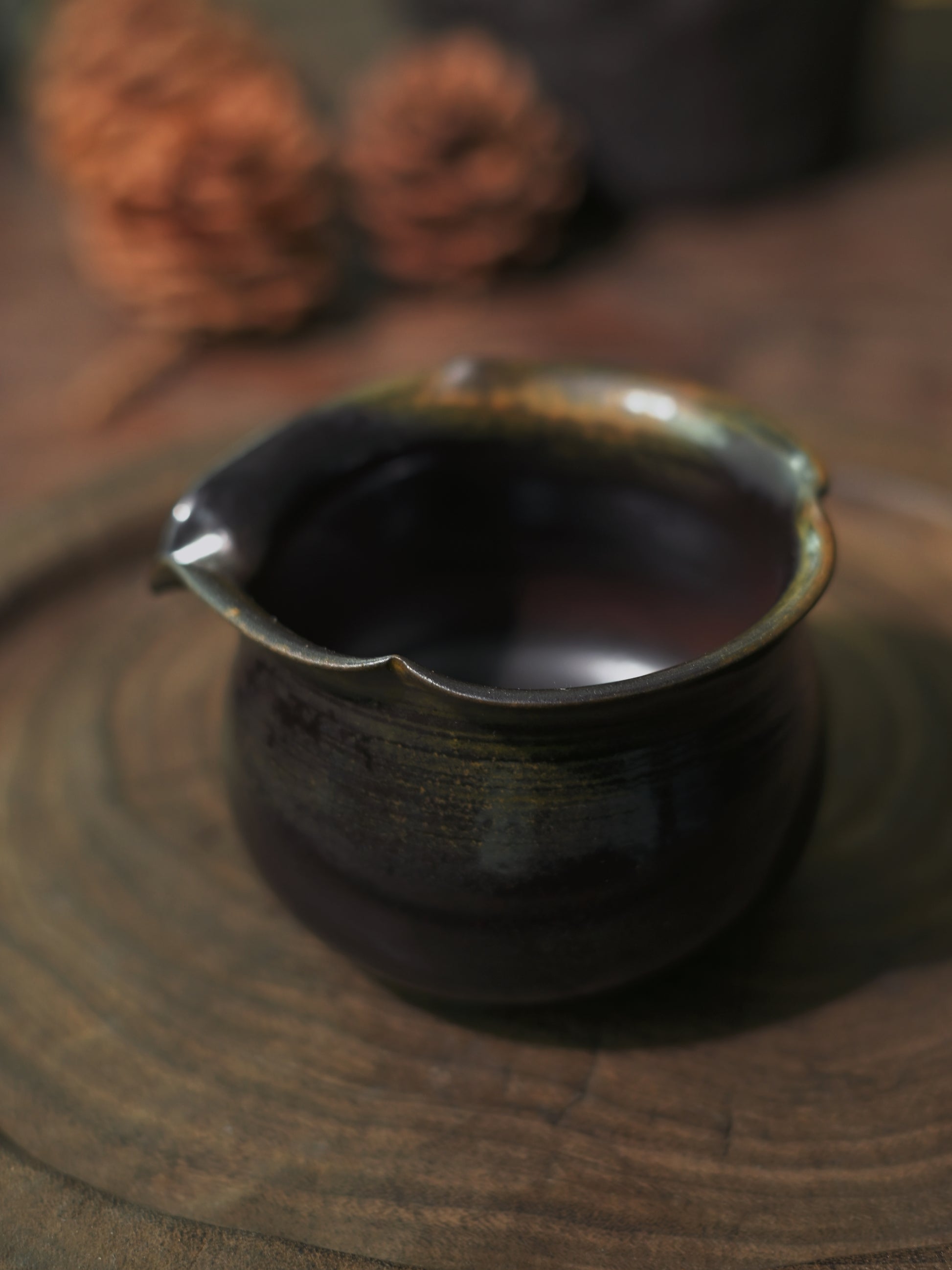 A masterfully crafted wood-fired stoneware Gong Dao Bei showing natural kiln effects.