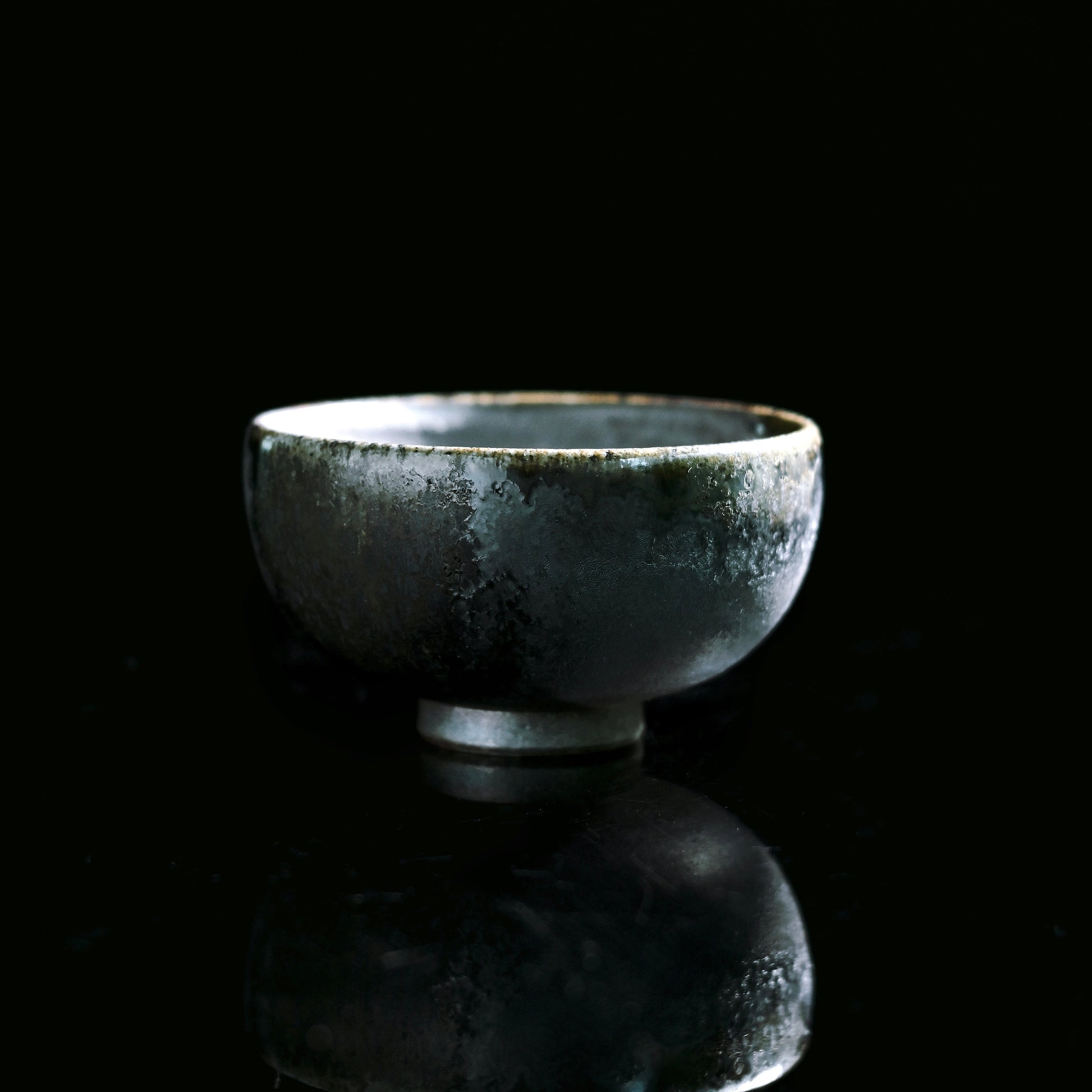 Handcrafted wood fired ash glaze tea cup showing natural pine ash fusion
