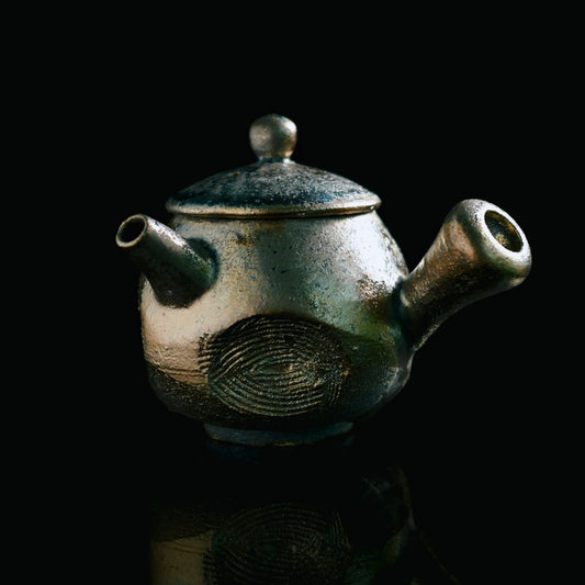 Handcrafted wood-fired teapot with natural ash glaze formed through 72-hour pine wood firing