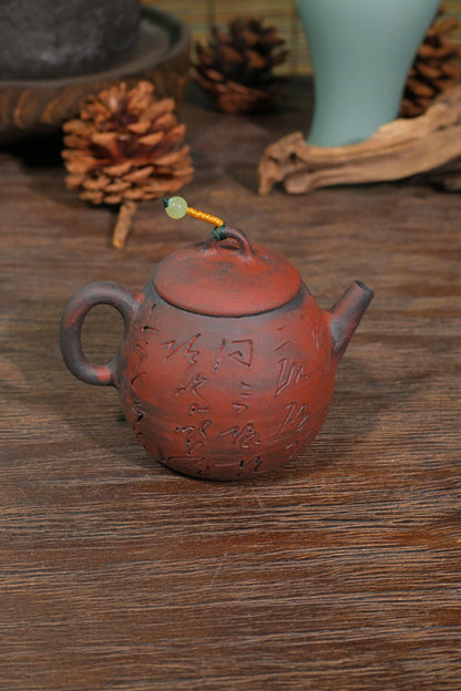 Close-up of 100ml wood-fired iron clay straight spout and comfortable C-handle for precise Gongfu tea pouring
