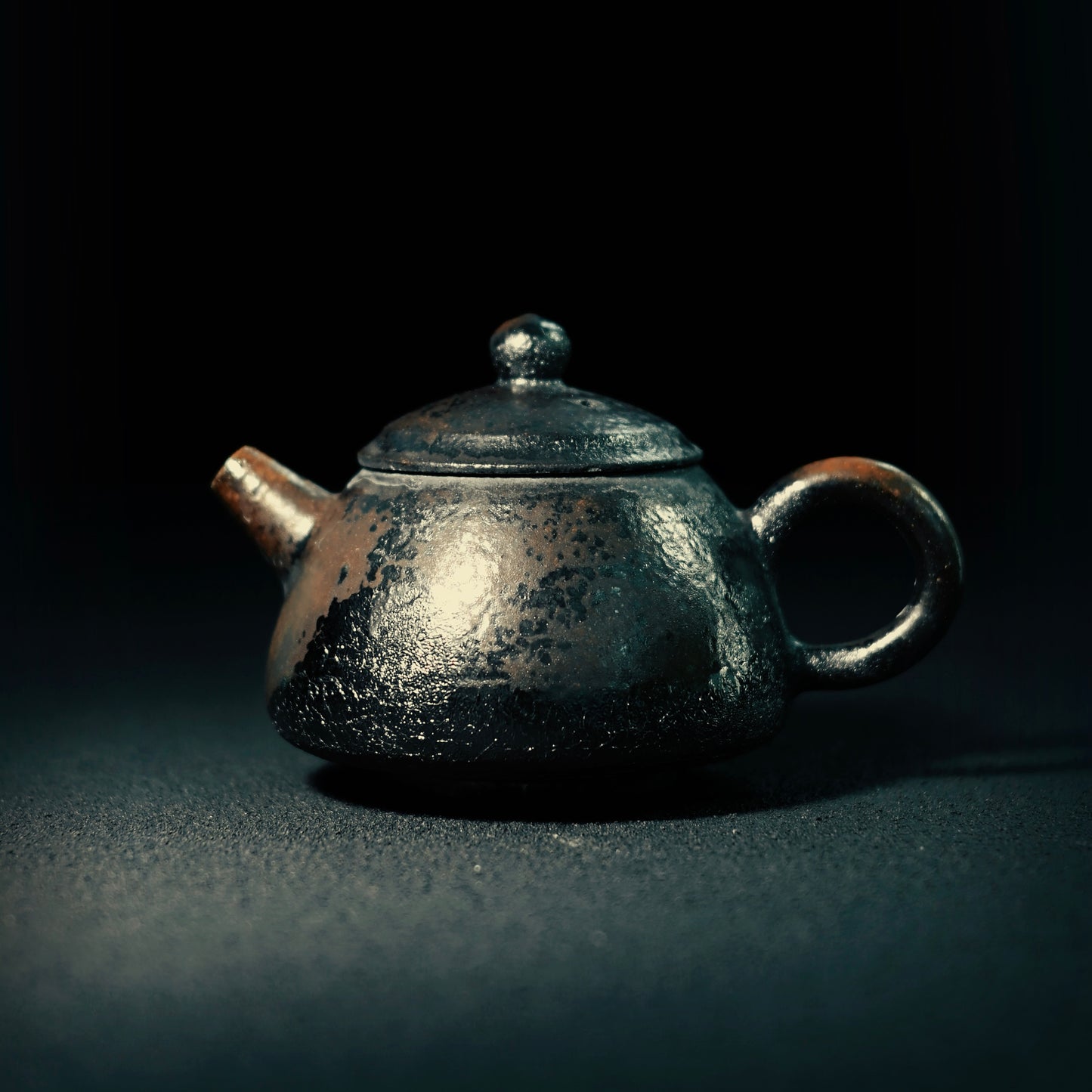 Handcrafted coarse clay teapot transformed through traditional wood firing process