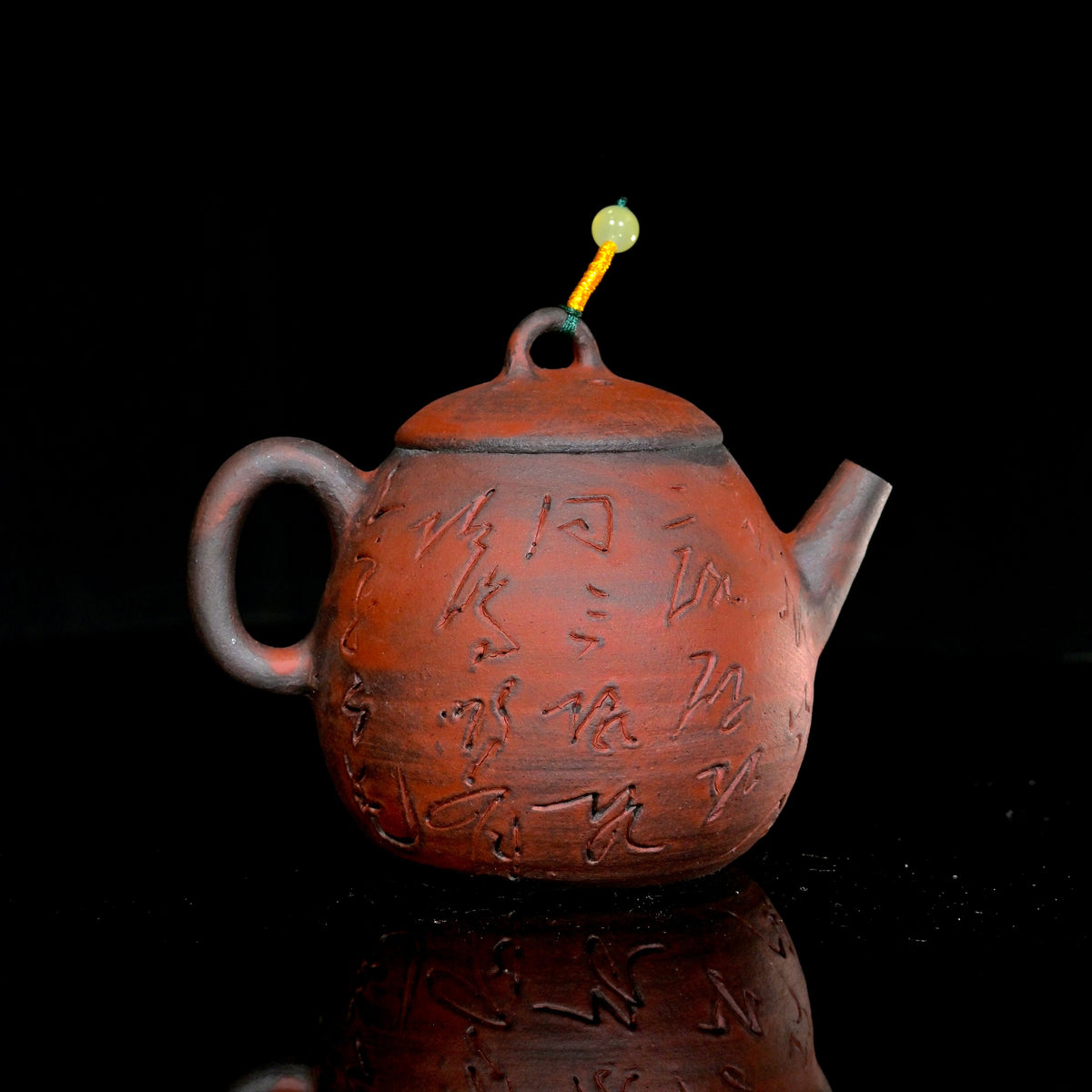 1-of-1 wood-fired 100ml iron-clay teapot with hand-carved cursive calligraphy and natural ash fire marks