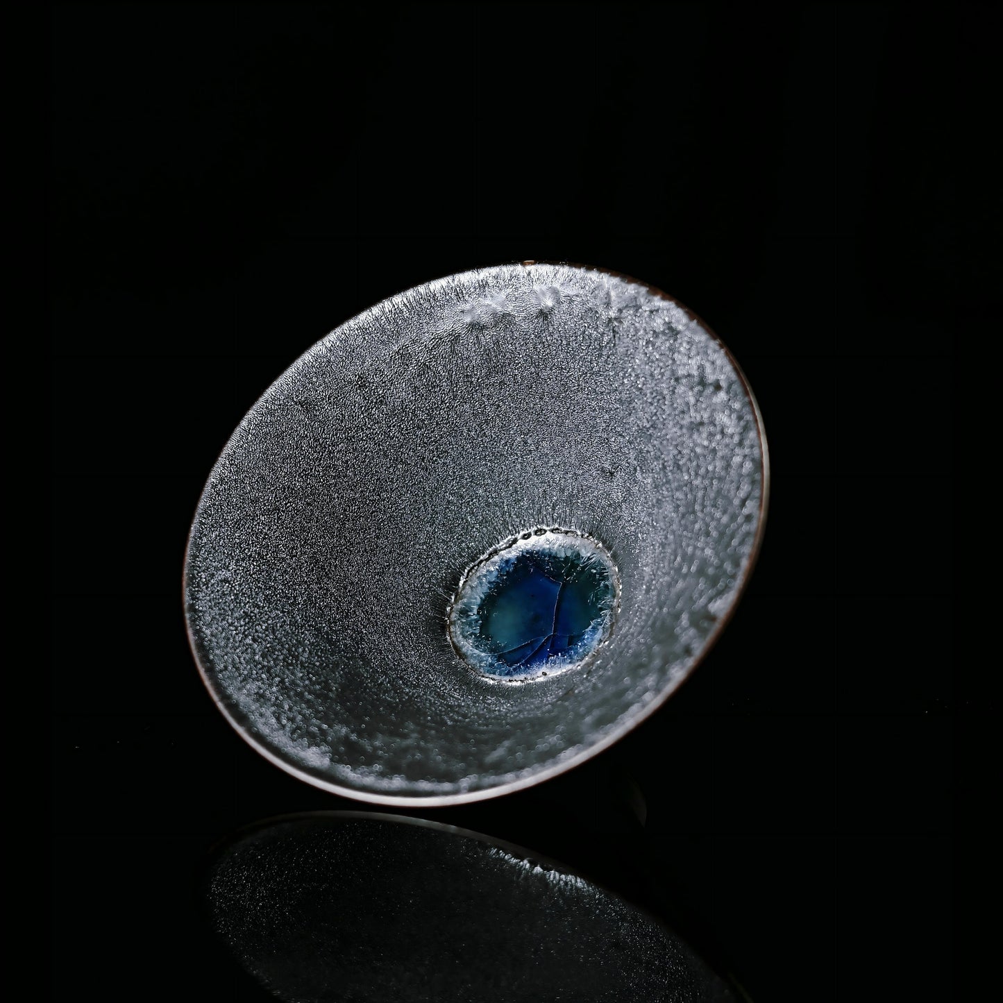 Wood-fired Jian Zhan tea cup inspired by kintsugi philosophy, featuring natural ash glaze and flame patterns