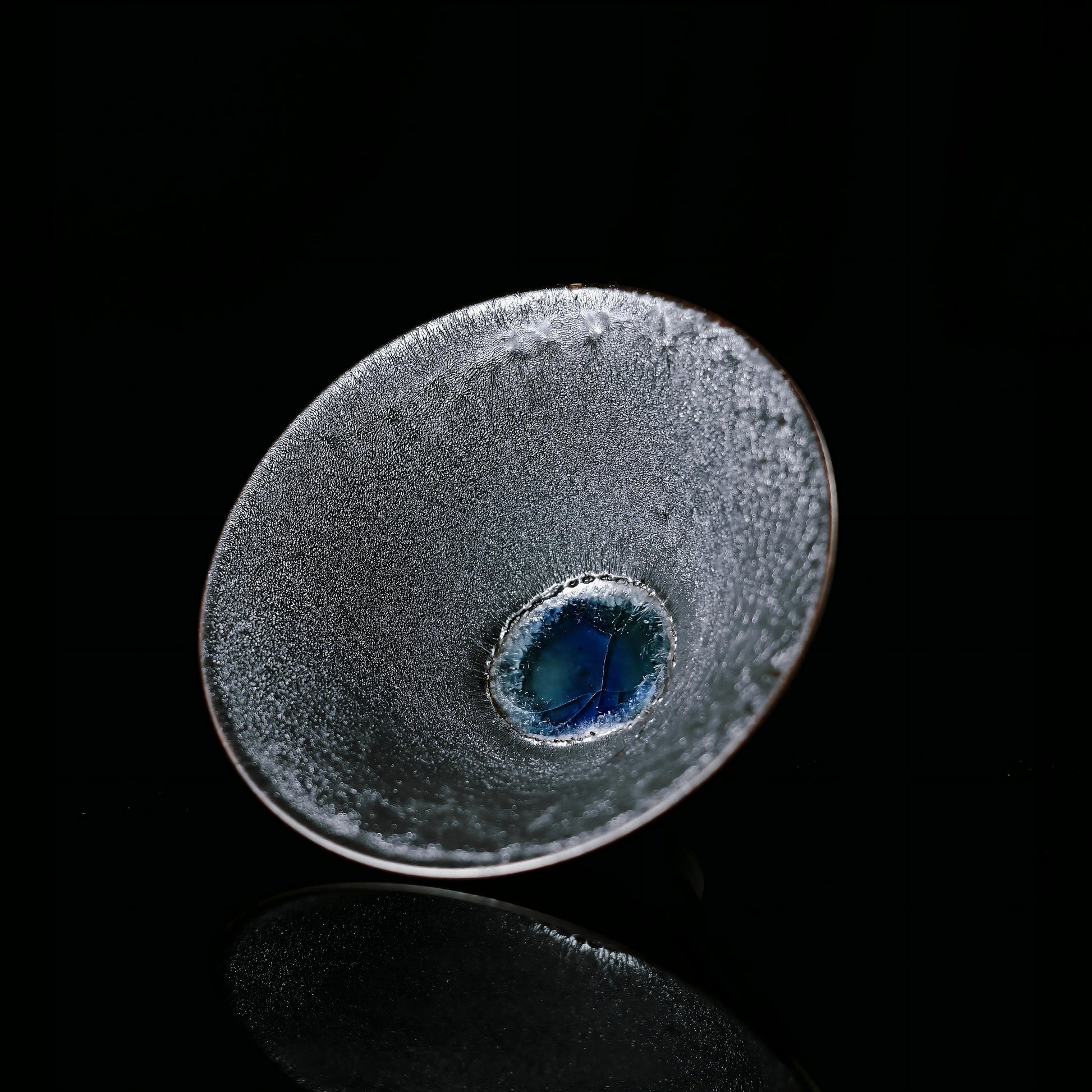 Wood-fired Jian Zhan tea cup inspired by kintsugi philosophy, featuring natural ash glaze and flame patterns