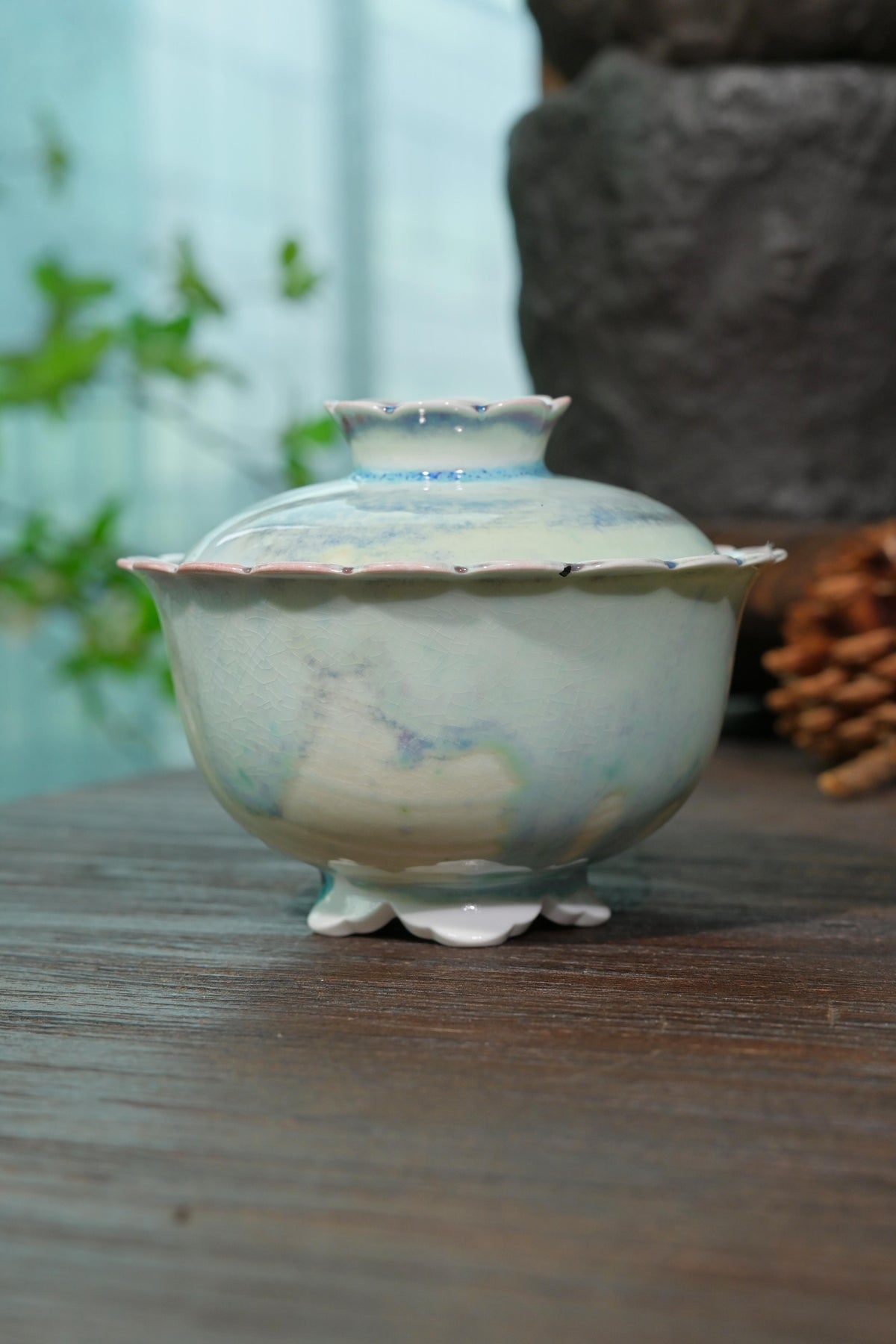 Close-up of wood-fired gaiwan scalloped flared lip designed for cool ergonomic finger grip