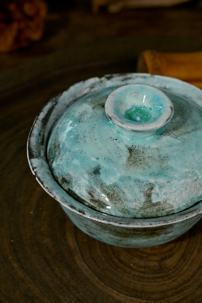Top view of 100ml wood-fired soda glazed blue gaiwan interior showing natural glaze variations