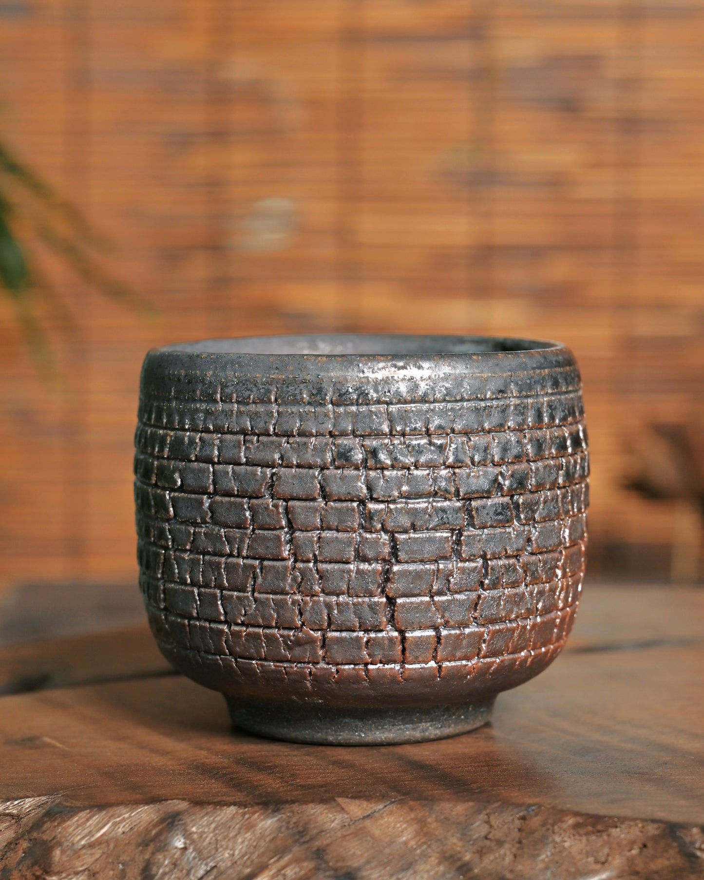 Close-up of crocodile-skin crackle texture on wood-fired iron clay teacup