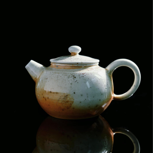 Handmade wood-fired teapot with natural ash glaze and fine crackle surface texture
