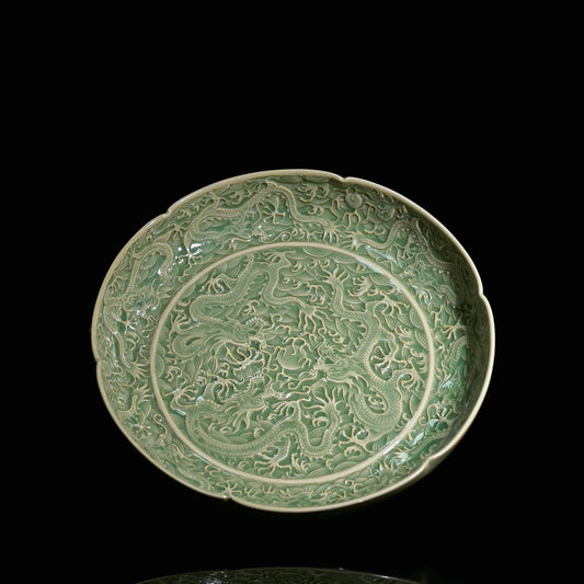 Yaozhou ware olive-green glazed plate with sharp carved nine dragons playing with a pearl motif