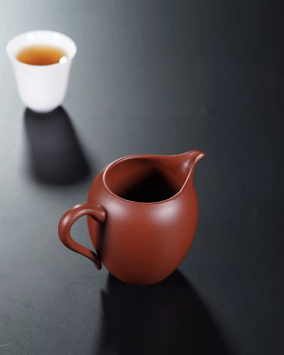 Ergonomically designed handle providing comfortable grip during tea serving ceremony