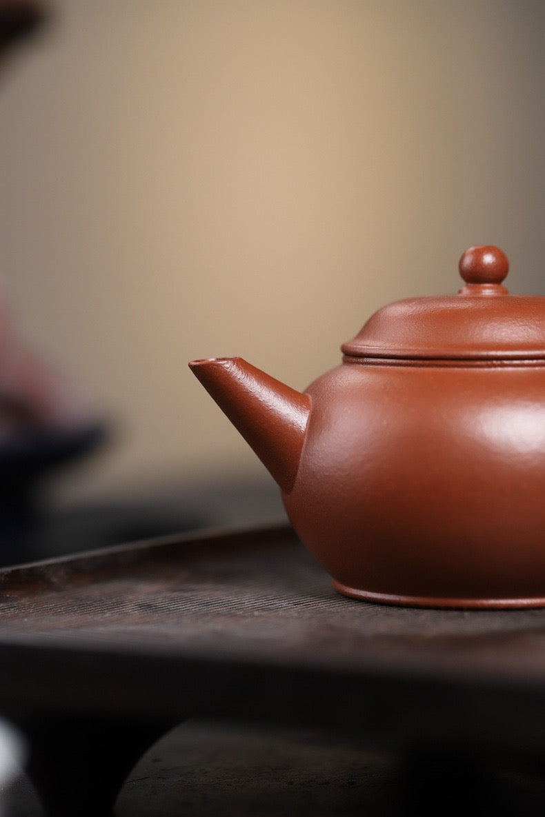 Rare Jiangpo clay teapot firing to orange-red with yellow tones, evoking Ming and Qing dynasty clay aesthetics