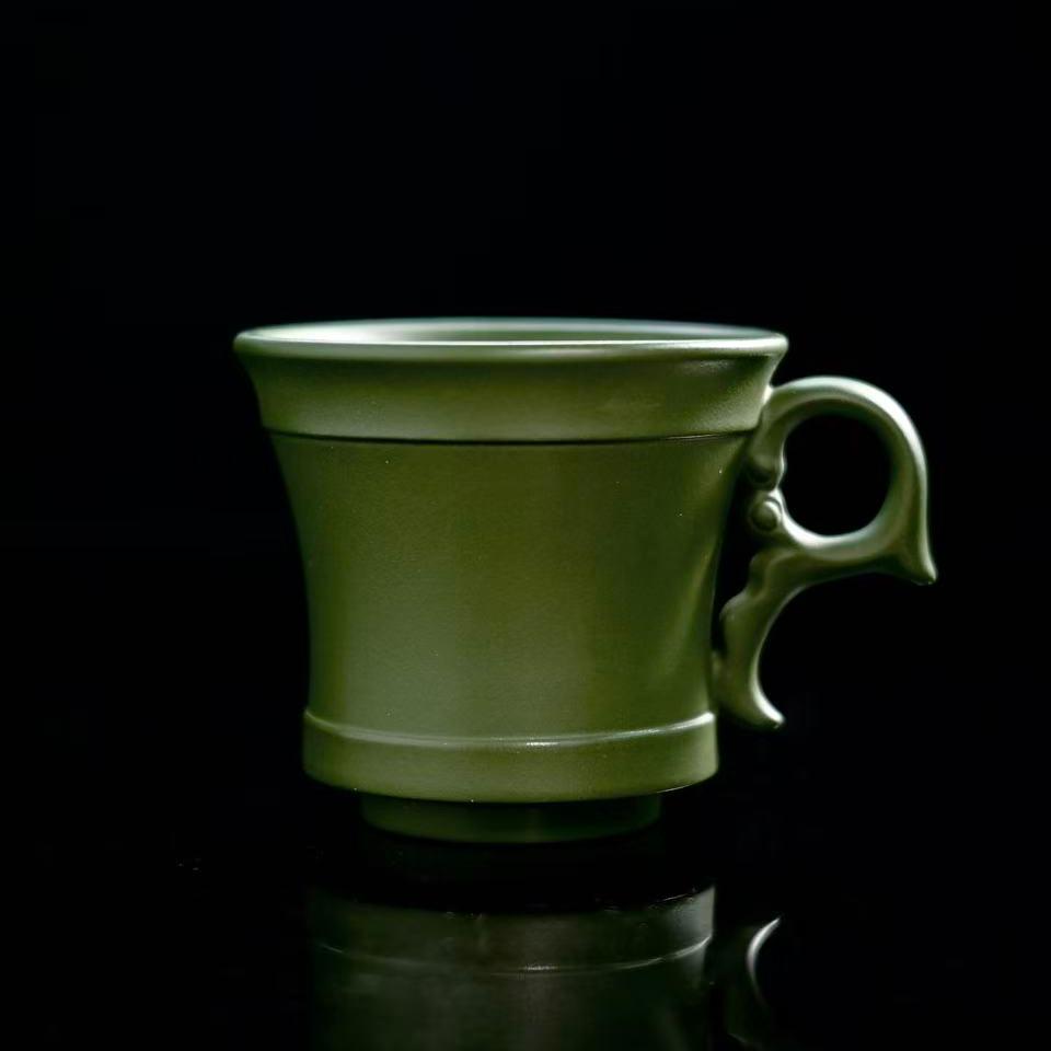 Yixing green clay side-handle tea cup showing minimalist form and natural clay texture
