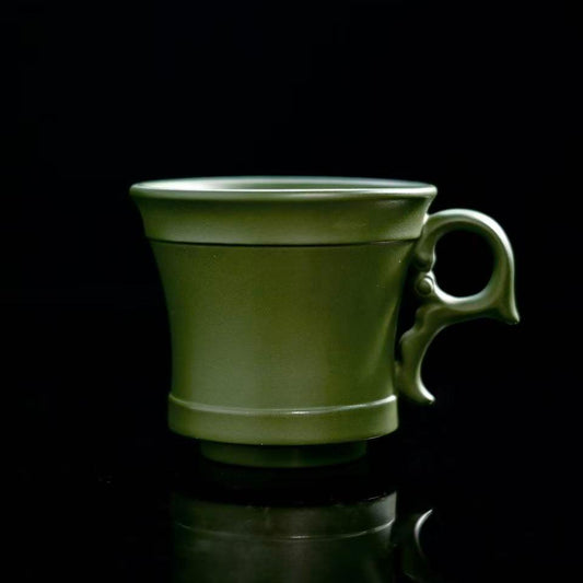 Yixing green clay side-handle tea cup showing minimalist form and natural clay texture