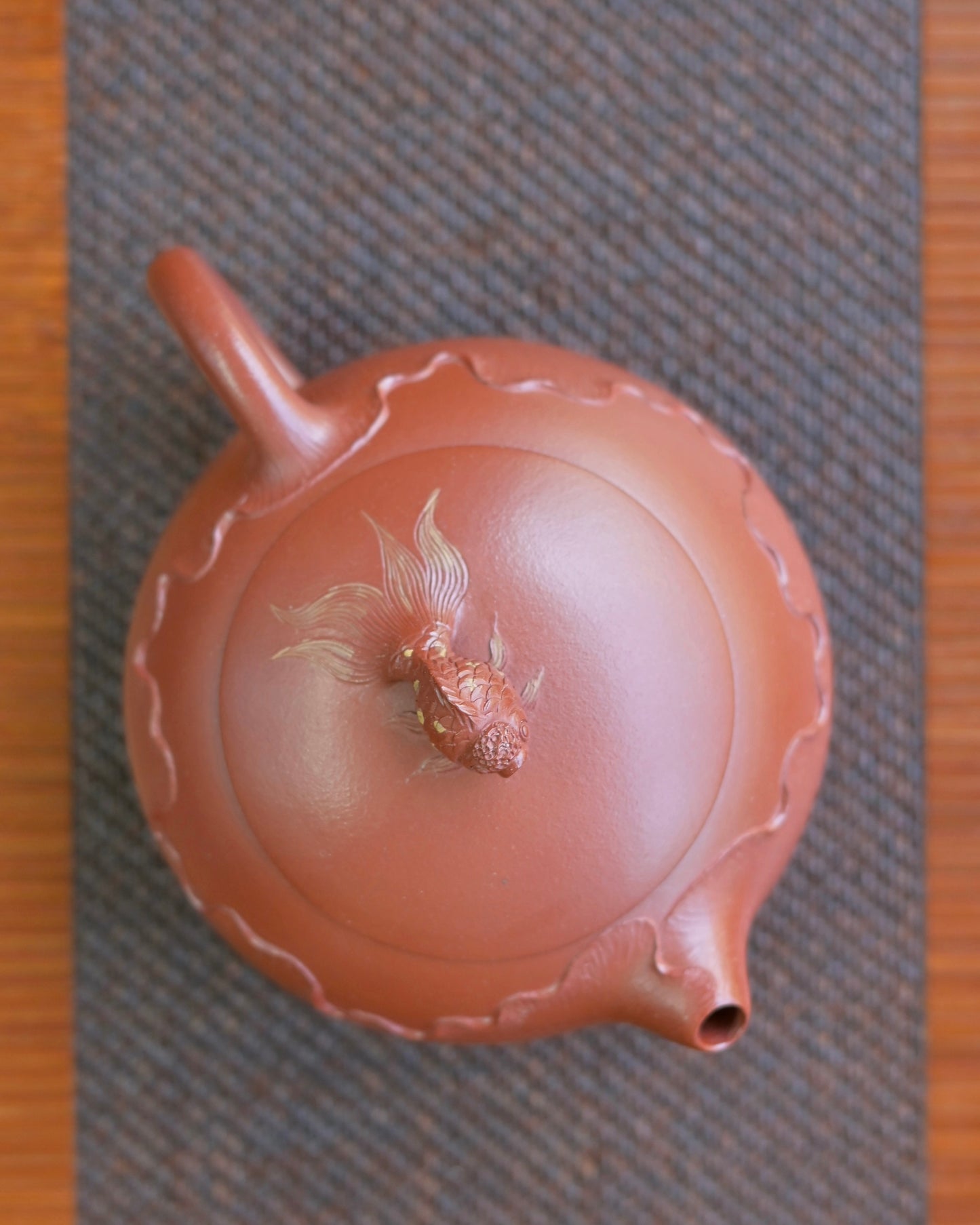 Semi-handmade vermilion teapot combining molded body with hand-carved goldfish and lotus decorations