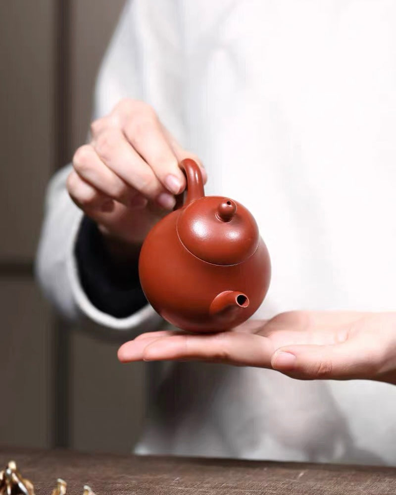 Iron oxide rich vermilion clay composition creating warm reddish-orange ceramic finish