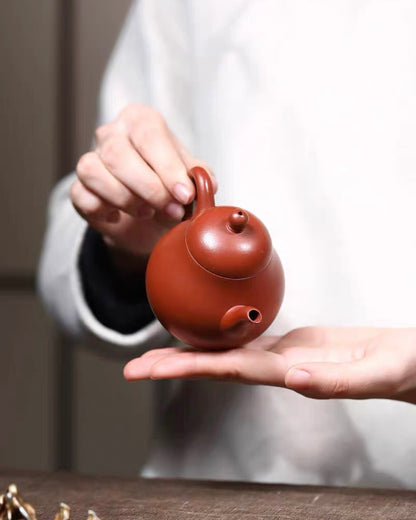 Iron oxide rich vermilion clay composition creating warm reddish-orange ceramic finish