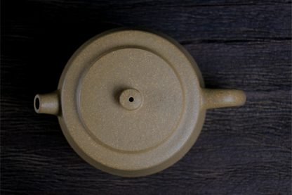 Han-style influenced teapot with modified proportions, featuring yellow Duan clay's natural grainy feel