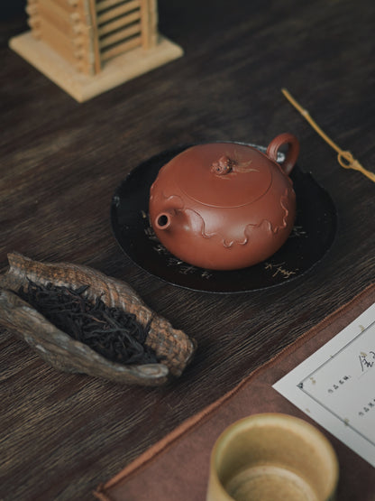 otus-embellished zhuni Xishi teapot: Nature's elegance meets artisan skill in this flattened form with flawless pouring and intricate hand-carved botanical details.