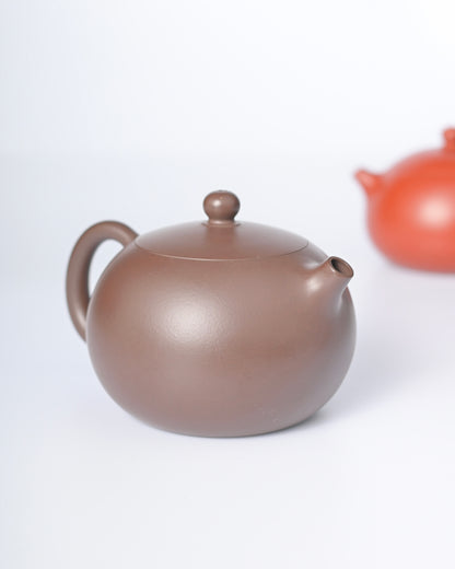 Premium zini clay Xishi teapot representing the pinnacle of Yixing's 10 classic forms. Museum-level craftsmanship meets perfect hydraulic function for serious tea connoisseurs.
