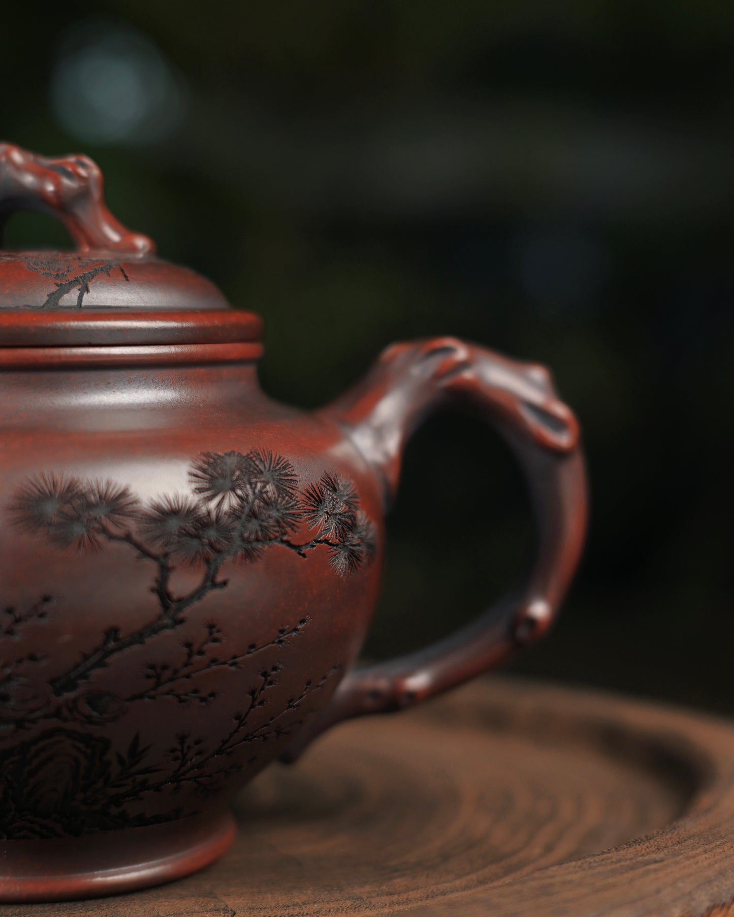Yixing teapot using dark clay with serpentine spout design ensuring steady, aerodynamic pour control during tea brewing