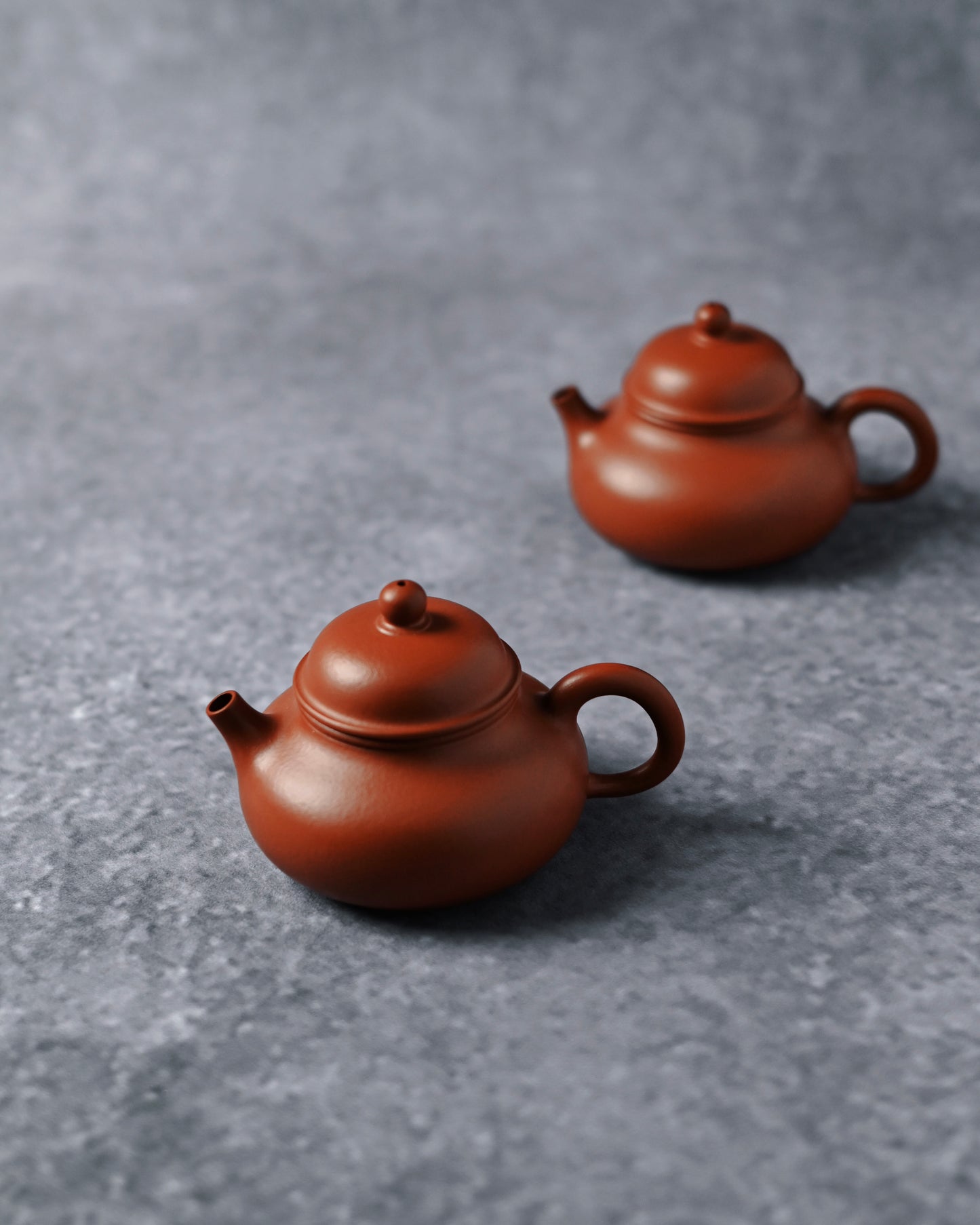 Rongtian classic teapot form characterized by swelling body, flush-fitting lid, and circular handle