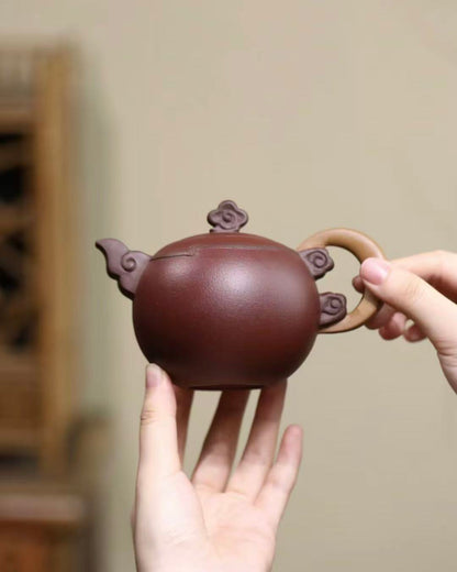 Yixing teapot showcasing artistic clouds and moon design in Zisha clay