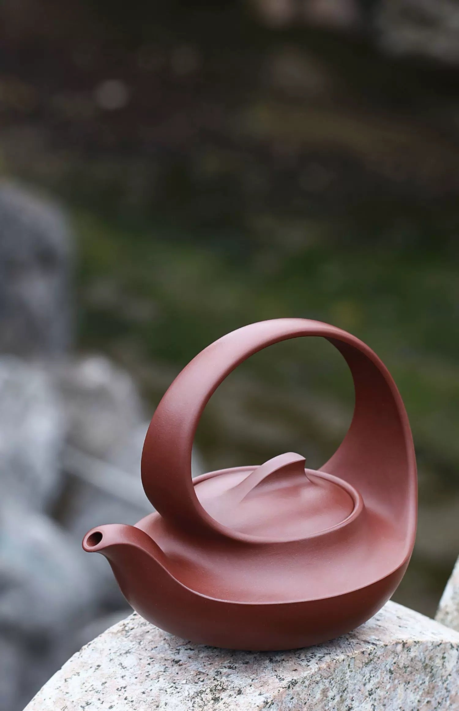Qu Pot ceramic teapot with organic snail form, continuous flowing lines from spout to handle, national design competition winner
