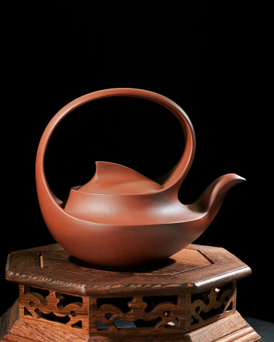 Qu Pot ceramic teapot with organic snail form, continuous flowing lines from spout to handle, national design competition winner