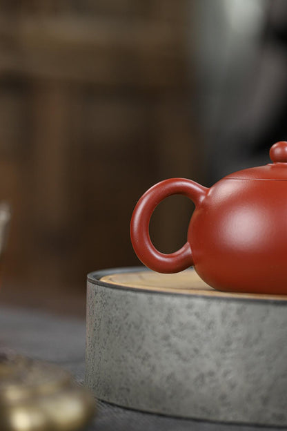 Hand-built Yixing zisha Xishi teapot in dahongpao clay - naturally enhances the complexity of pu'erh and oolong through micro-oxidation.