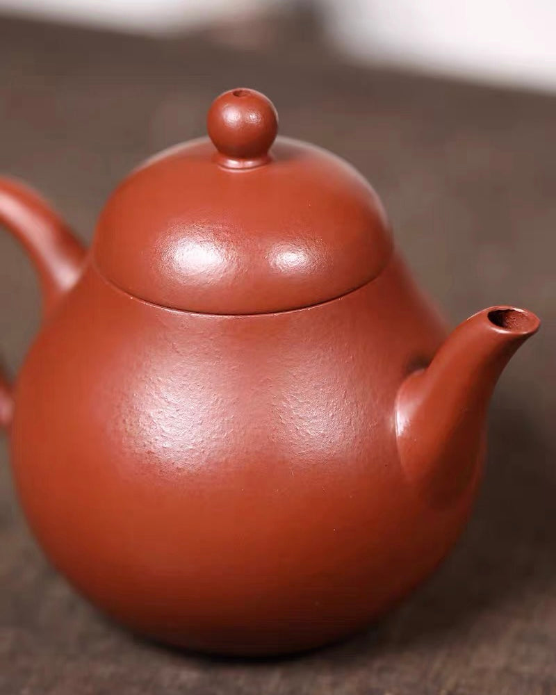 High-fired unglazed Yixing clay surface developing natural patina through repeated tea use