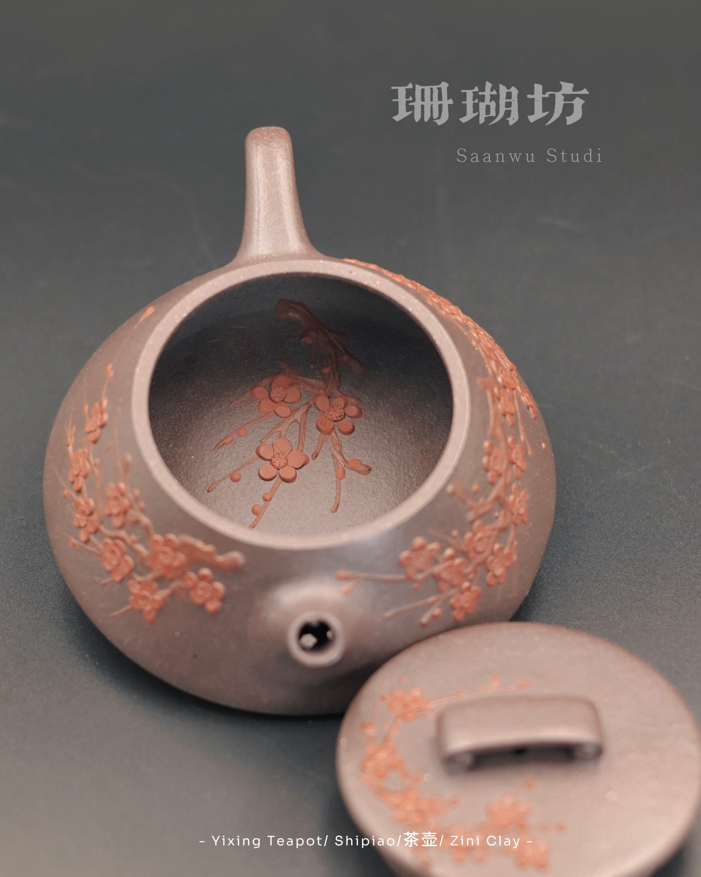 Handcrafted Yixing teapot with plum blossom carving on body