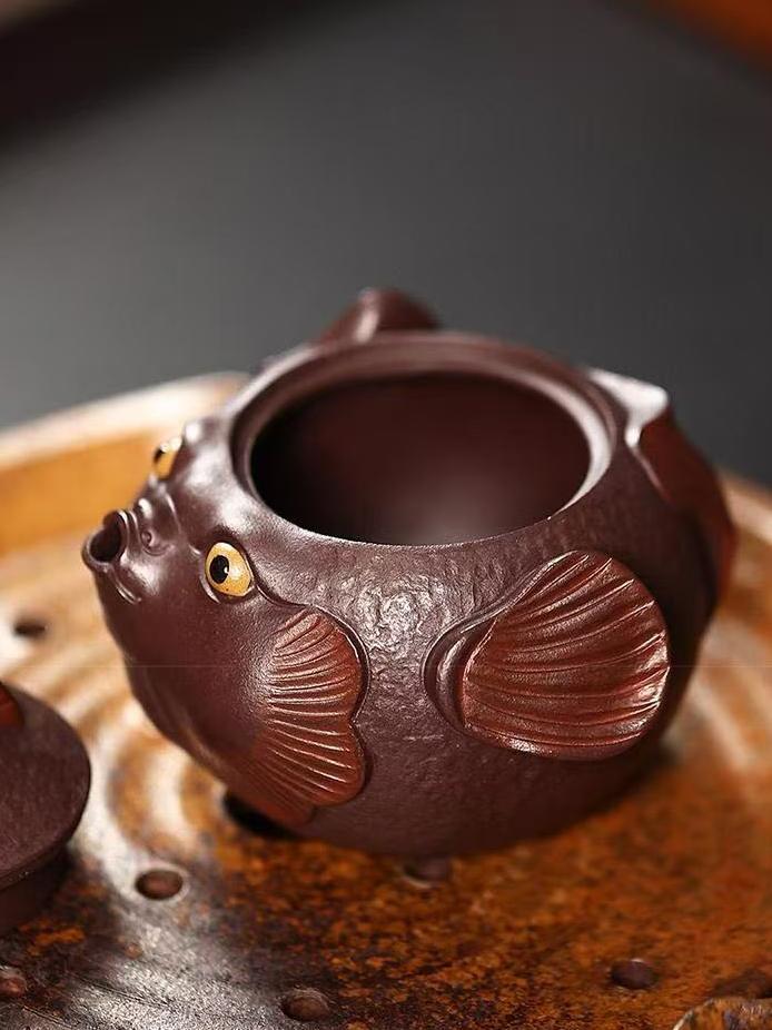 Playful yet professional pufferfish teapot adding joy to tea rituals - handcrafted from authentic Yixing aged purple clay.
