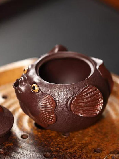 Playful yet professional pufferfish teapot adding joy to tea rituals - handcrafted from authentic Yixing aged purple clay.