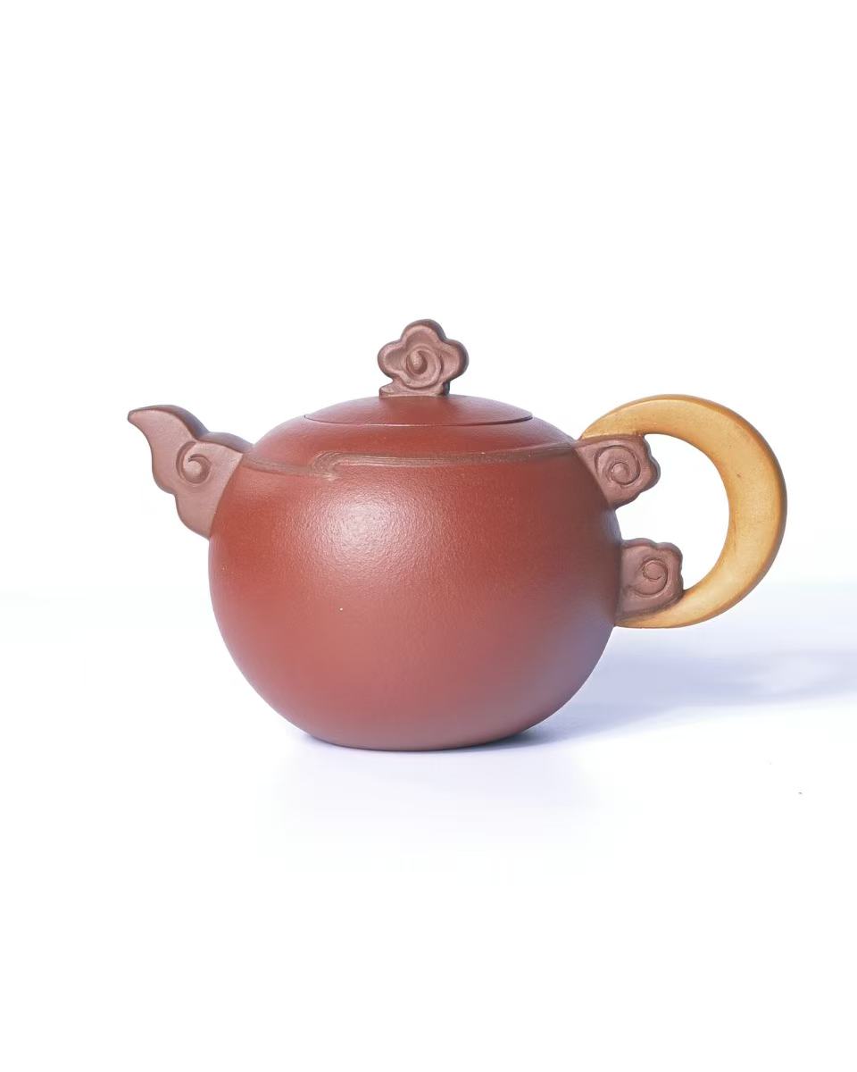 Traditional purple clay teapot featuring cloud and moon motif