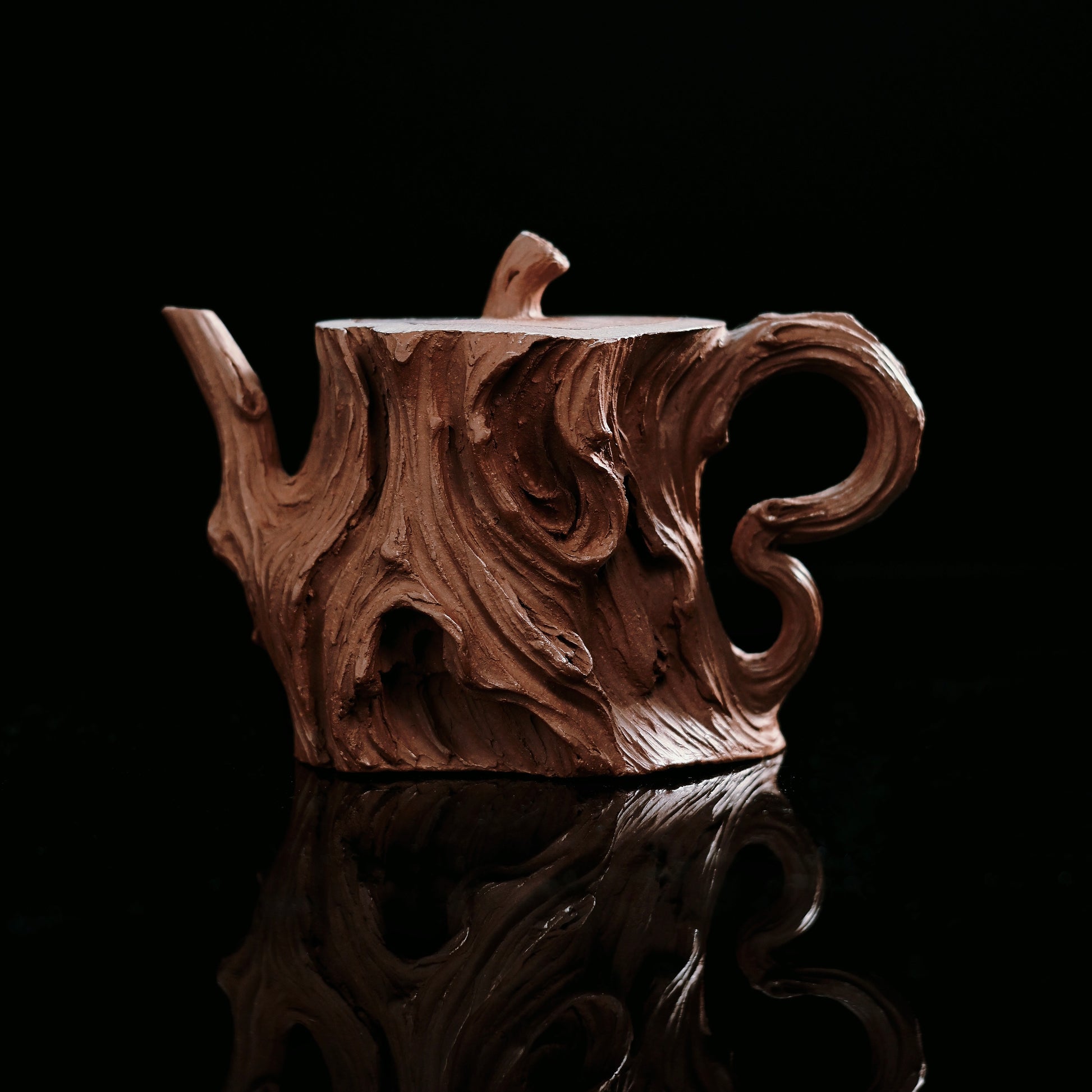 Yixing Zisha tree stump teapot front view showing bold asymmetrical form and bark texture