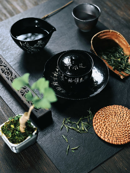 Gloss black glazed tea set featuring silver oxide brushwork and intentional crackle textures, handcrafted for chanoyu with distressed aesthetic and poetic inscriptions.